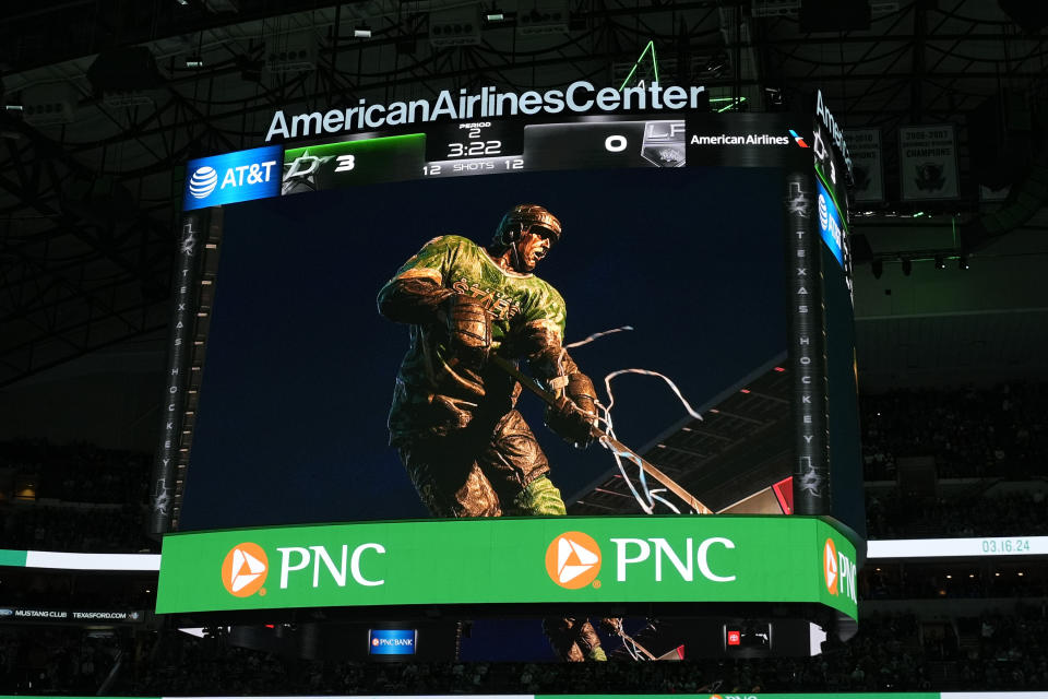 A statue of former Dallas Stars Mike Modano is displayed on the scoreboard screen after an unveiling during an NHL hockey game between the Los Angeles Kings and Dallas Stars in Dallas, Saturday, March 16, 2024. The ceremony was moved inside due to rain. (AP Photo/LM Otero)