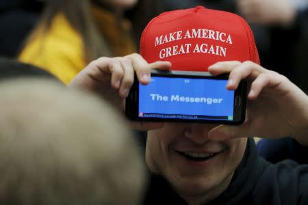 Audience member Jack Greene plays a game of charades with a friend before a campaign rally with U.S. Republican presidential candidate Donald Trump in Marshalltown, Iowa January 26, 2016. REUTERS/Brian Snyder