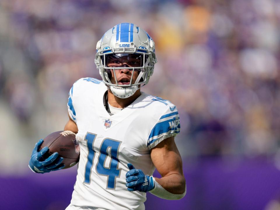 Amon-Ra St. Brown runs after a catch against the Minnesota Vikings.