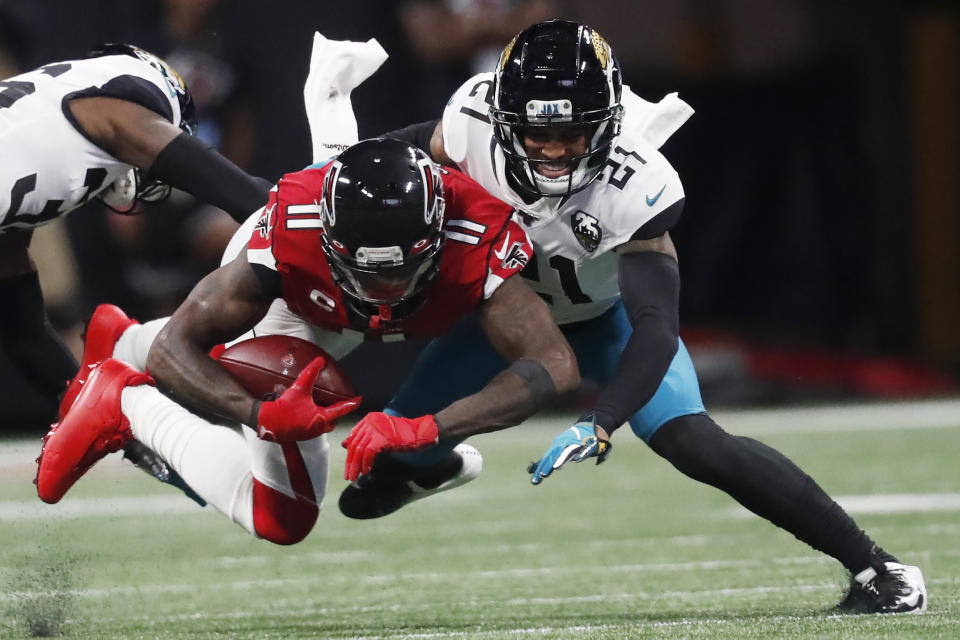Jacksonville Jaguars cornerback A.J. Bouye (21) tackles Atlanta Falcons wide receiver Julio Jones (11) during the first half of an NFL football game, Sunday, Dec. 22, 2019, in Atlanta. (AP Photo/John Bazemore)
