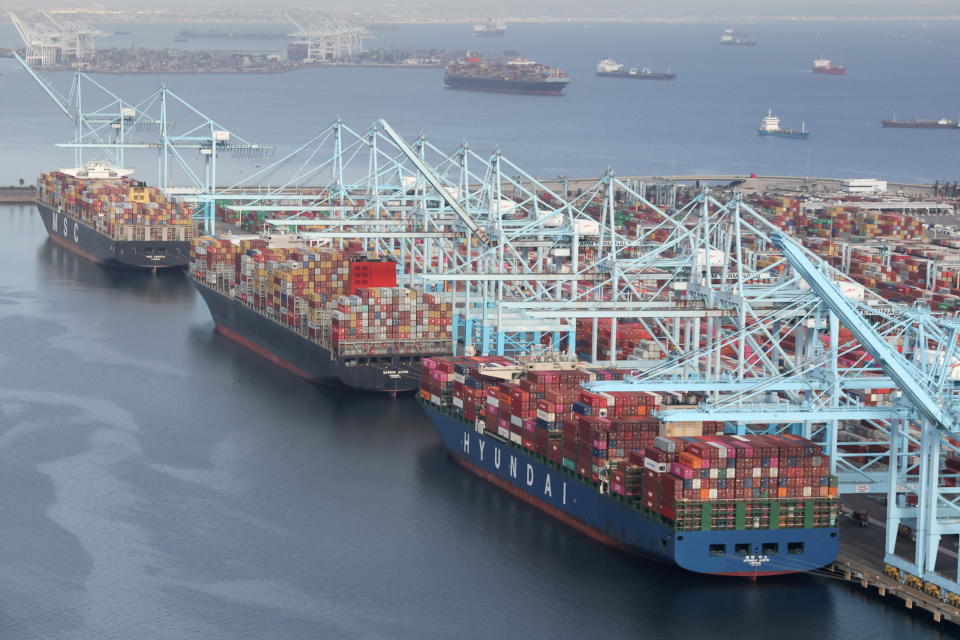 Shipping containers are unloaded from ships at a container terminal at the Port of Long Beach-Port of Los Angeles complex, amid the coronavirus disease (COVID-19) pandemic, in Los Angeles, California, U.S., April 7, 2021. REUTERS/Lucy Nicholson