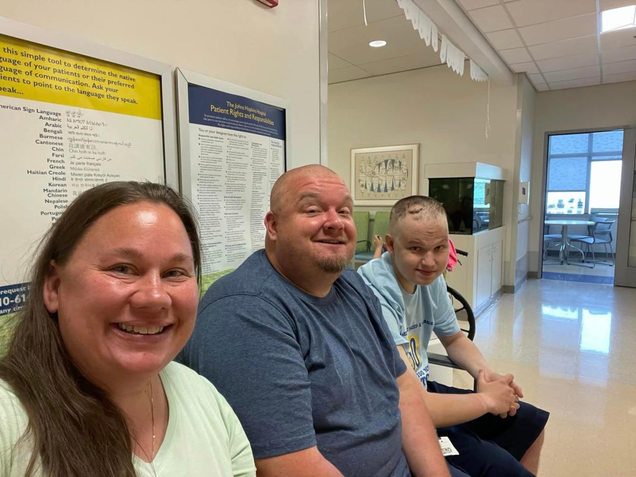 Zachary Gorsuch, right, sits with his parents, Crystal and Rob before getting a treatment at Johns Hopkins in June 2023.