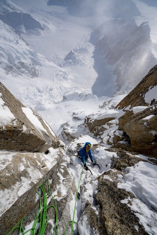 Climber in Alaska ascends steep face.