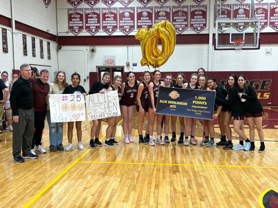 The Park Ridge girls basketball team honors Allie Shenloogian (beneath balloons) after the junior scored her 1,000th career point in a season-opening 56-28 win over Pompton Lakes on Dec. 14, 2023.