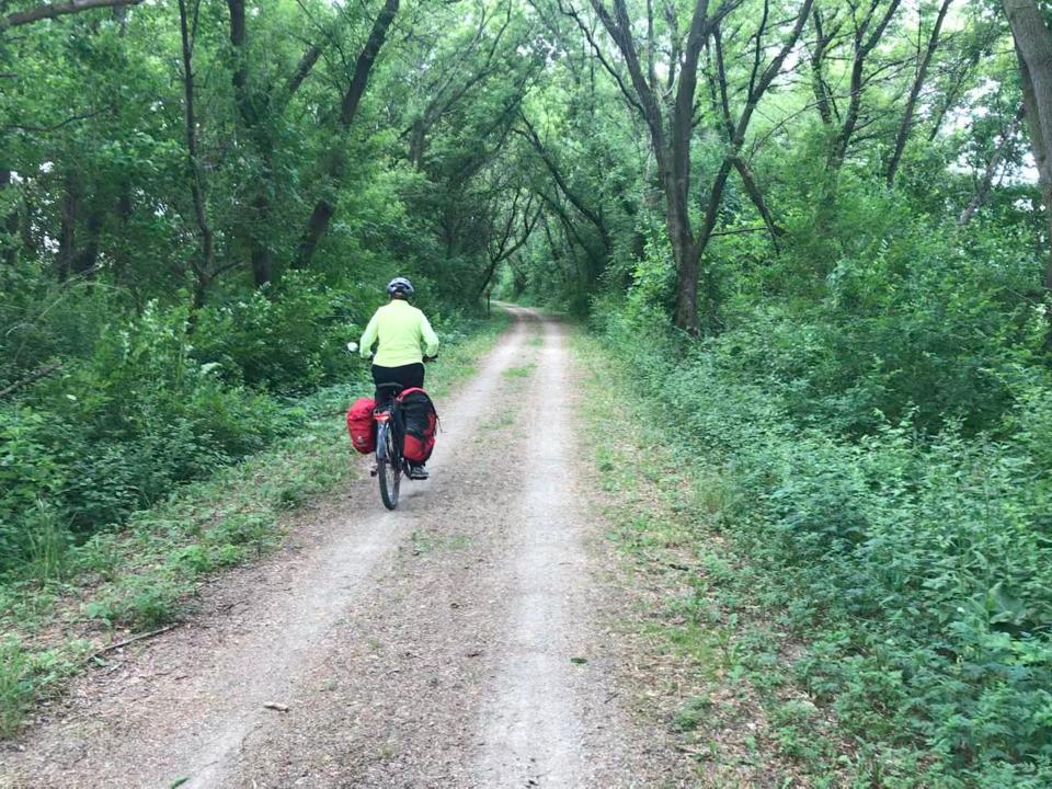 Sonja Gurda rides along the Glacial Drumlin Trail shortly before rain begins.