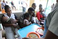 Food is served in a program for undernourished children at St. Luke Hospital in Port-au-Prince