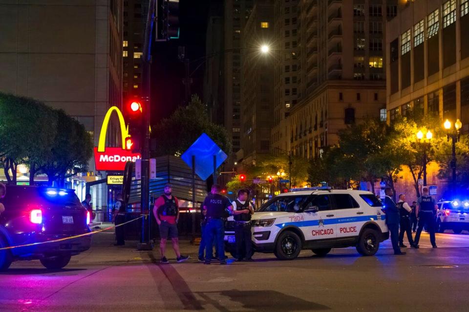 Chicago police work at the scene of a shooting near East Chicago Avenue and North State Street in the Near North Side neighborhood, Thursday, May 19, 2022 in Chicago.