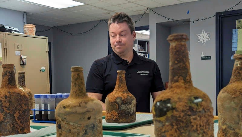 Archeologist Jason Boroughs discusses artifacts found underneath George Washington's residence in Mount Vernon, Va., Monday, June 17, 2024. Earlier this year, a few dozen 18th-century glass bottles containing fruit were unearthed in the mansion cellar of America's first president.