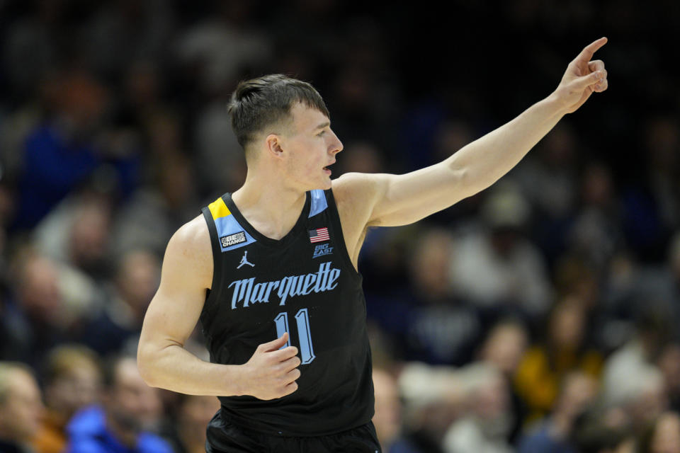 Marquette guard Tyler Kolek (11) reacts after scoring during the first half of an NCAA college basketball game against Xavier, Sunday, Jan. 15, 2023, in Cincinnati. (AP Photo/Jeff Dean)