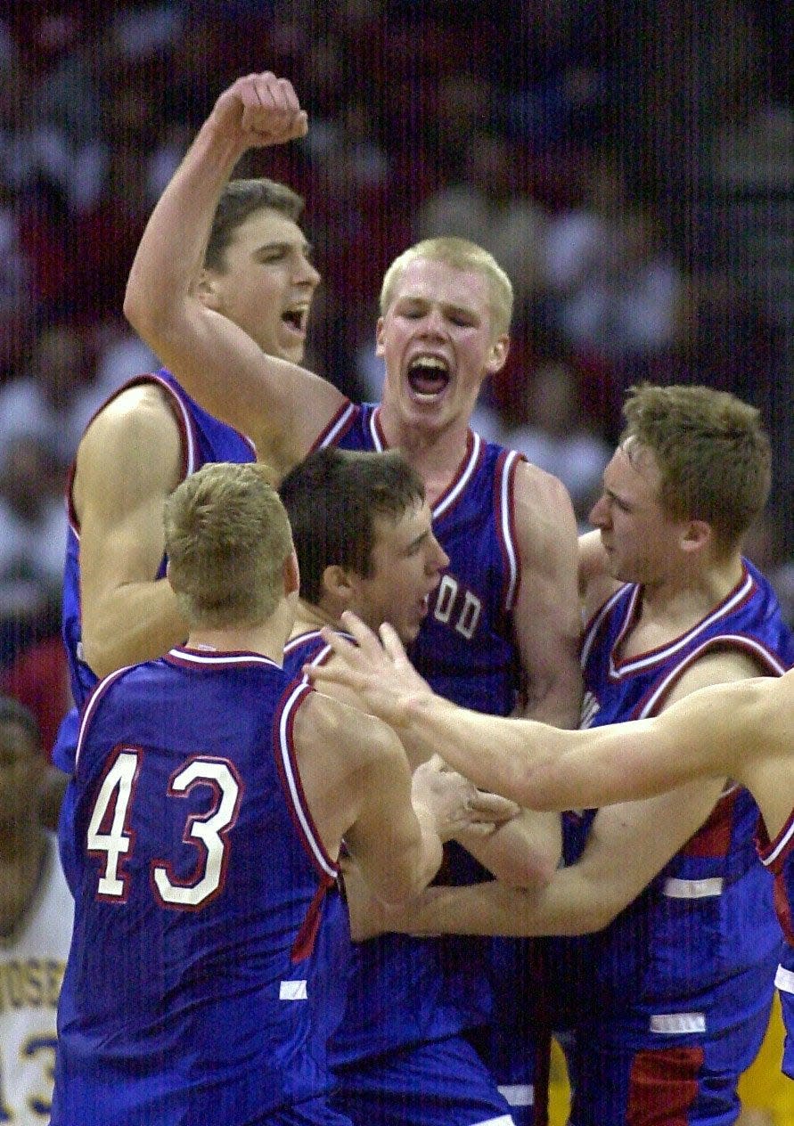 Glenwood City's Scott Miller, center, celebrates along with his teammates after Miller hit a game-winning three-point shot in Glenwood City's 70-67 victory over Kenosha St. Joseph in a Division 3 semifinal game at the WIAA state tournament in Madison on Thursday, March 15, 2001.