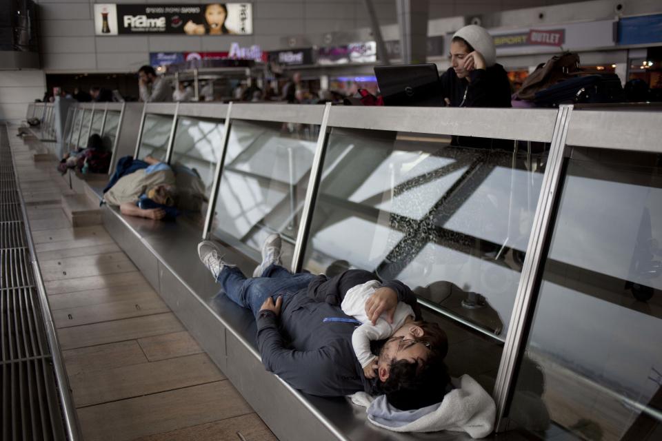 Passengers wait in a departure hall at the Ben Gurion airport near Tel Aviv, Israel, Sunday, April 21, 2013. Israel's three airlines went on strike Sunday over a proposed "Open Skies" deal with the European Union that union workers say jeopardizes their jobs and could even cause the local airline industry to collapse. (AP Photo/Ariel Schalit)