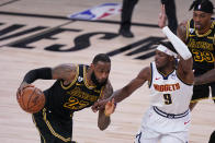 Los Angeles Lakers' LeBron James (23) drives past Denver Nuggets' Jerami Grant (9) during the second half of an NBA conference final playoff basketball game Sunday, Sept. 20, 2020, in Lake Buena Vista, Fla. (AP Photo/Mark J. Terrill)