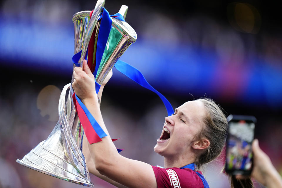 Barcelona's Caroline Graham Hansen celebrates with the trophy after winning the women's Champions League final soccer match between FC Barcelona and Olympique Lyonnais at the San Mames stadium in Bilbao, Spain, Saturday, May 25, 2024. Barcelona won 2-0. (AP Photo/Jose Breton)