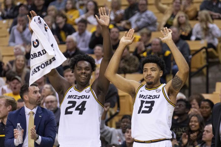 Missouri's Kobe Brown, left, and Ronnie DeGray III, right, celebrate a teammate's basket during the second half of an NCAA college basketball game against Coastal Carolina Wednesday, Nov. 23, 2022, in Columbia, Mo. Missouri won 89-51.(AP Photo/L.G. Patterson)