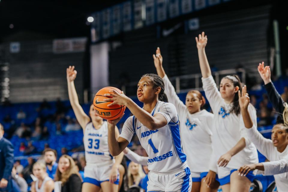 MTSU's Courtney Blakely fires a 3-pointer as the Lady Raider bench reacts during Wednesday's Conference USA game vs. Rice, won by the Lady Raiders 85-56.