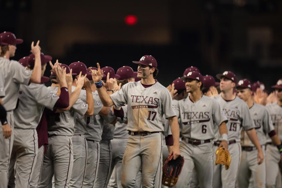 The Texas A&M Aggies high-five each other during the Kubota College Baseball Series at Globe Life Field in March. The Aggies will host the College Station Regional beginning Friday.