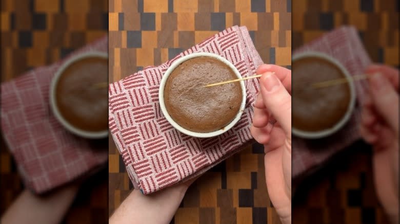 Doing the toothpick test on a chocolate lava cake