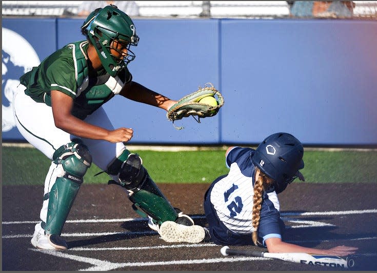 Bartlesville High baserunner Kenzie Denny, right, avoids the tags during varsity softball play on Aug. 14, 2023, in Bartlesville.