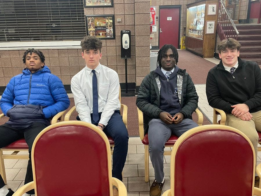 Aquinas football players attend the press conference of new head coach Maurice Jackson on Tuesday, Jan. 10, 2023. From left to right: CJ Robinson, Ben Newman, Trent Hill and Lucas Leone.