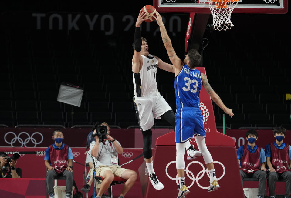 Italy's Achille Polonara, right, and Germany's Moritz Wagner fight a rebound during men's basketball preliminary round game at the 2020 Summer Olympics, Sunday, July 25, 2021, in Saitama, Japan. (AP Photo/Eric Gay)