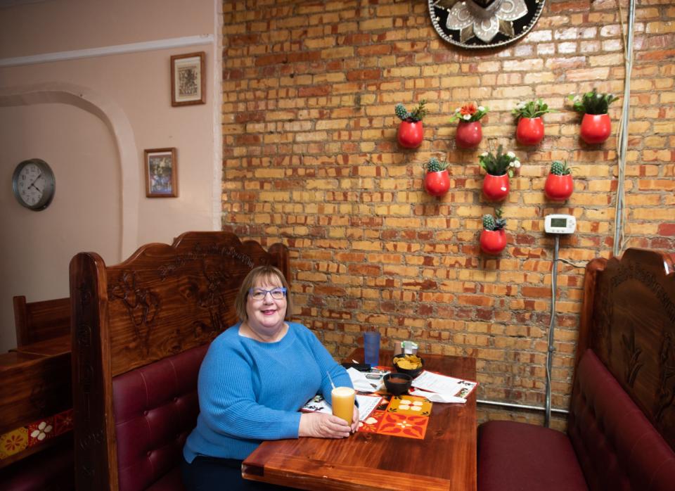 Amy Piper, author of "100 Things to Do in Lansing Before You Die," pictured Tuesday, March 29, 2022, at Pablo's Old Town in Lansing, one of the 100 places she recommends visiting in her book about Lansing.