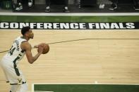 Milwaukee Bucks' Giannis Antetokounmpo shoots a free throw during the first half of Game 2 of the NBA Eastern Conference basketball finals game Friday, June 25, 2021, in Milwaukee. (AP Photo/Morry Gash)