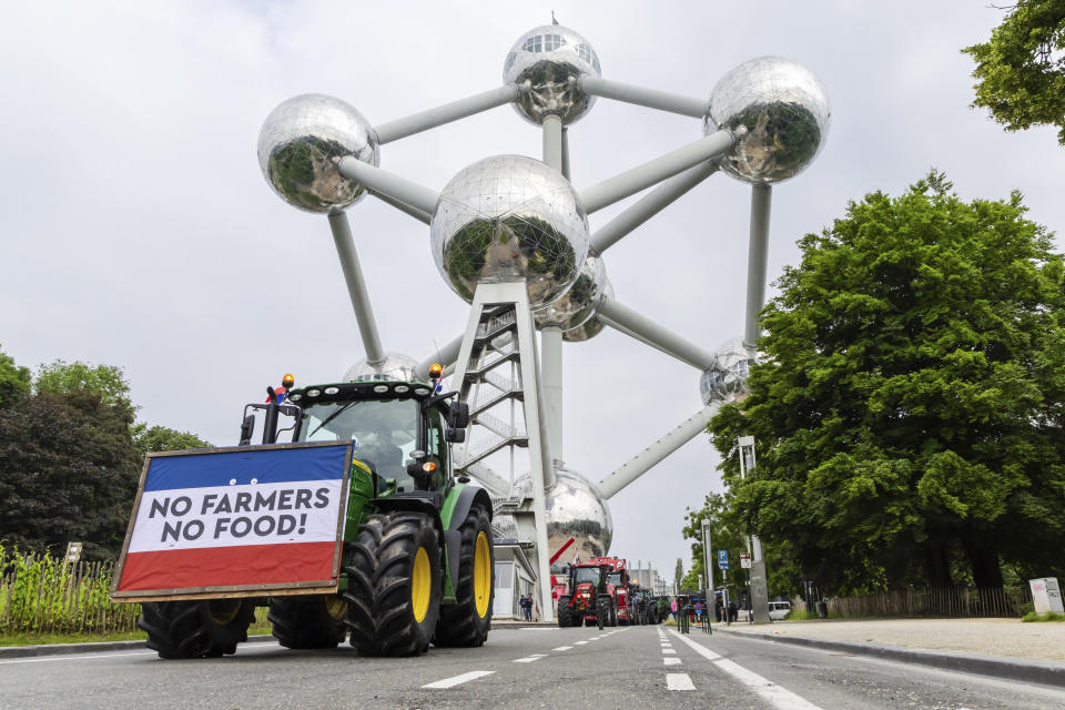 Farmers with their tractors gather around the Atomium, in Brussels, Tuesday, June 4, 2024. On Tuesday, militant agricultural groups from more than a half dozen nations were converging on EU headquarters in a show of force that they hoped would sweep the progressive Green Deal climate pact off the table in the wake of the elections and give farmers the leeway they had for so long in deciding how to till the land. (AP Photo/Geert Vanden Wijngaert)