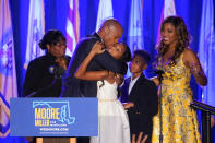 Democrat Wes Moore, second from left, hugs his daughter, Mia, center, as Moore's mother, Joy Thomas Moore, left, his son, Jamie, second from right, and his wife, Dawn, look on after he spoke to supporters during an election night gathering after he was declared the winner of the Maryland gubernatorial race, Tuesday, Nov. 8, 2022, in Baltimore. (AP Photo/Julio Cortez)
