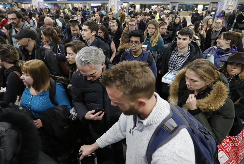 Amtrak passengers wait to take an escalator to a train platform, Wednesday, Nov. 21, 2018, at New York's Penn Station. (AP Photo/Mark Lennihan)