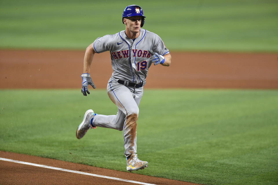 New York Mets' Mark Canha (19) scores from third on a sacrifice fly during the third inning of a baseball game against the Miami Marlins, Saturday, April 1, 2023, in Miami. (AP Photo/Michael Laughlin)