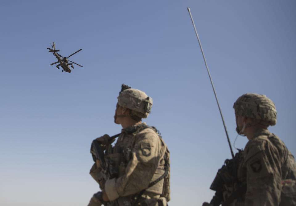 FILE - This June 10, 2017 file photo released by the U.S. Marine Corpsshows an AH-64 Apache attack helicopter provides security from above while CH-47 Chinooks drop off supplies to U.S. Soldiers with Task Force Iron at Bost Airfield, Afghanistan. When he pulled the plug on the American war in Afghanistan, President Joe Biden said the reasons for staying, 10 years after the death of al-Qaida leader Osama bin Laden, had become "increasingly unclear.” Now that the final withdrawal is under way, questions about clarity have shifted to Biden's post-withdrawal plan. (U.S. Marine Corps photo by Sgt. Justin T. Updegraff, Operation Resolute Support via AP)