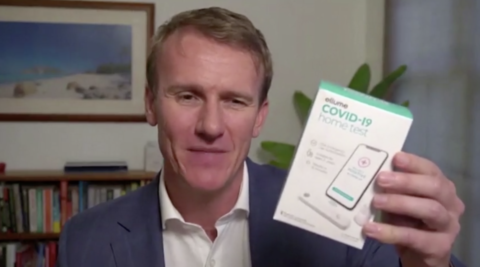 Ellume Chief Executive Officer Dr Sean Parsons holds a Covid-19 testing kit.