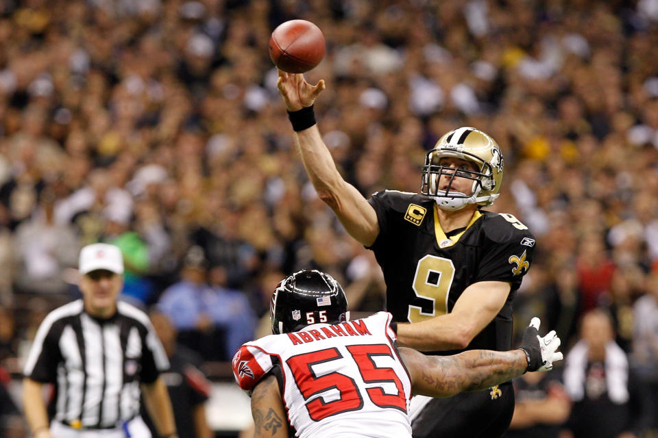 NEW ORLEANS, LA - DECEMBER 26: Quarterback Drew Brees #9 of the New Orleans Saints throws the ball as defensive end John Abraham #55 of the Atlanta Falcons rushes in during the second quarter at the Mercedes-Benz Superdome on December 26, 2011 in New Orleans, Louisiana. (Photo by Chris Graythen/Getty Images)