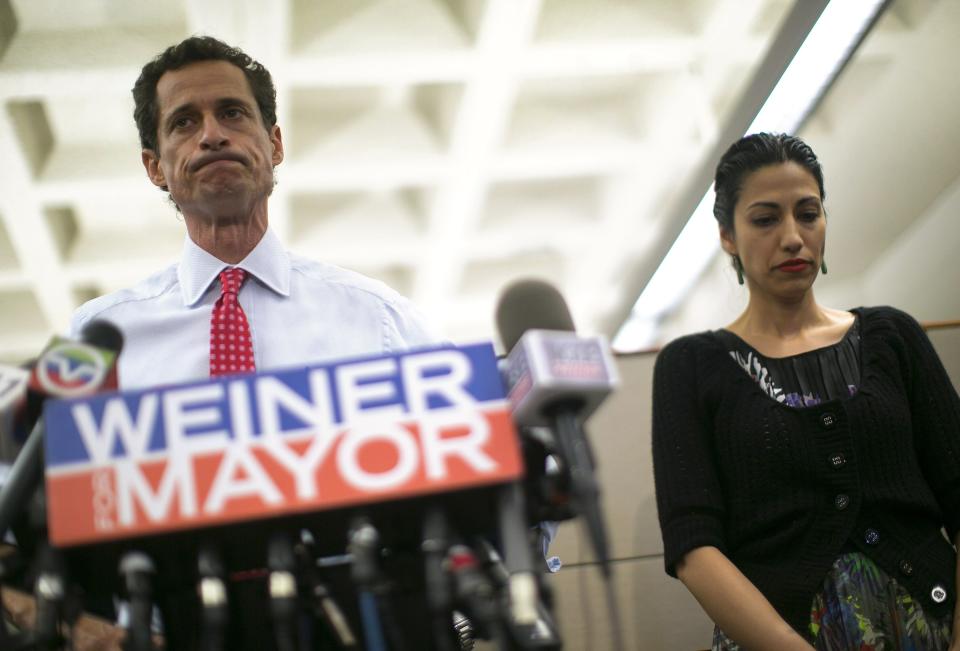 New York mayoral candidate Anthony Weiner and his wife Huma Abedin attend a news conference in New York, in this July 23, 2013, file photo. In the category of "Politicians Behaving Badly," former Congressman Anthony Weiner's run to become New York City's next mayor lost steam when news broke that the Democrat - who resigned from Congress in 2011 after a sexting scandal - was at it again, this time under the code name "Carlos Danger." REUTERS/Eric Thayer/Files (UNITED STATES - Tags: POLITICS MEDIA ELECTIONS)
