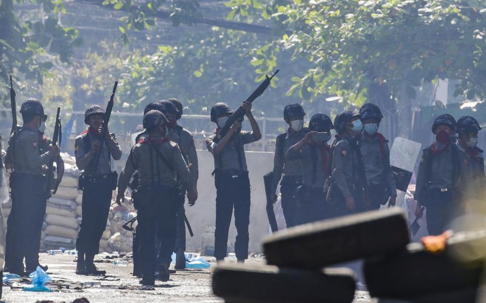 Police officers search for hiding demonstrators during a protest in Yangon on March 8 - LYNN BO BO/EPA-EFE/Shutterstock 