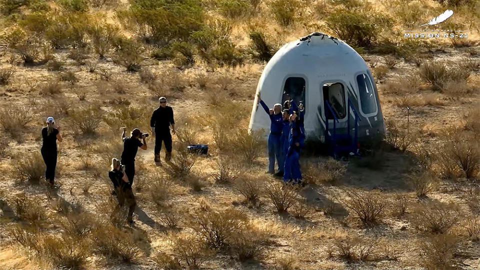 All six crew members greet recovery crews and pose for photos moments after touching down. / Credit: Blue Origin webcast