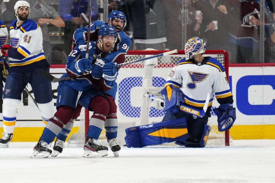 Colorado Avalanche left wing Gabriel Landeskog (92) celebrates a goal against the St. Louis Blues with Nazem Kadri (91) during the third period in Game 2 of an NHL hockey Stanley Cup second-round playoff series Thursday, May 19, 2022, in Denver. (AP Photo/Jack Dempsey)