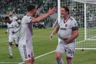 St Louis City FC Tim Parker (26) holds the ball under his jersey as he celebrates his goal against the Austin FC with teammate Eduard Lowen, left, during the first half of an MLS soccer match in Austin, Texas, Saturday, Feb. 25, 2023. (AP Photo/Eric Gay)