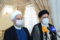 Iran's outgoing President Rouhani and Iran's President-elect Raisi speak to the media after their meeting, in Tehran