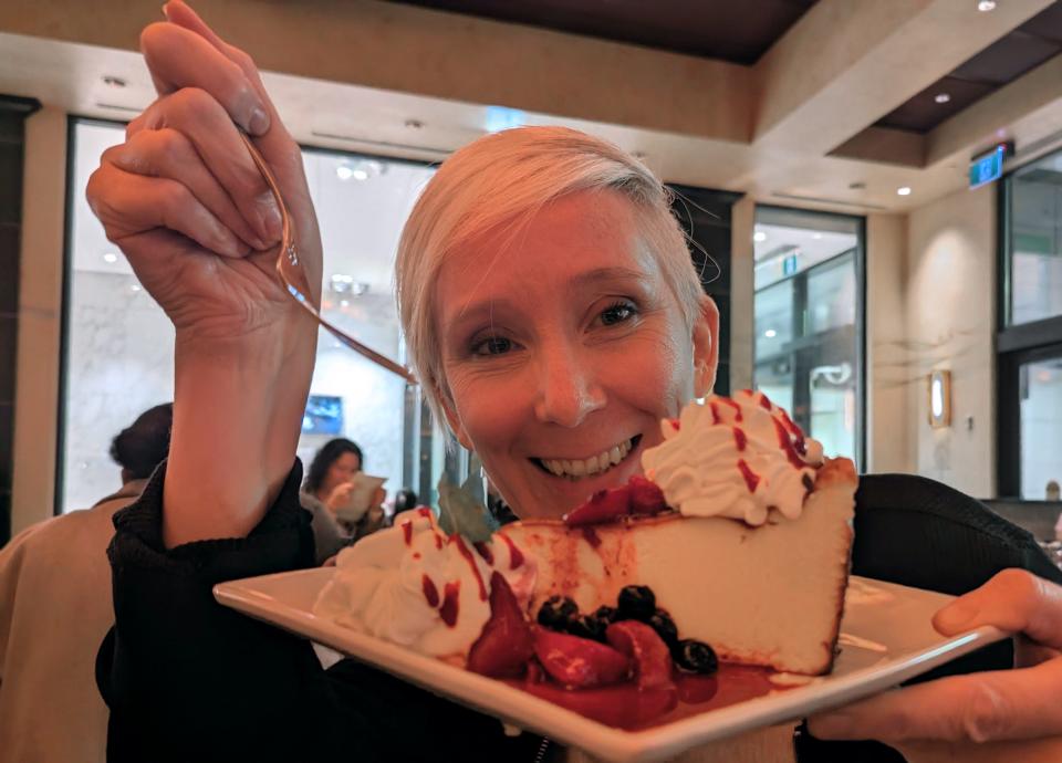 aefa holding cheesecake and a fork