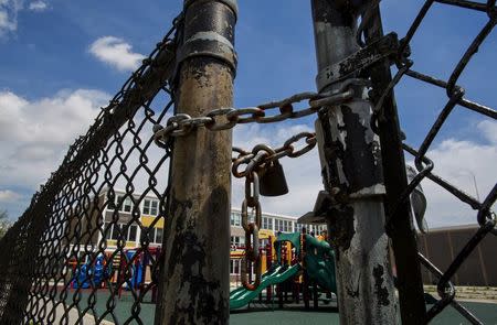 A playground is seen behind a locked gate at Woods Elementary Math & Science Academy in Chicago, Illinois, United States, May 8, 2015. REUTERS/Jim Young