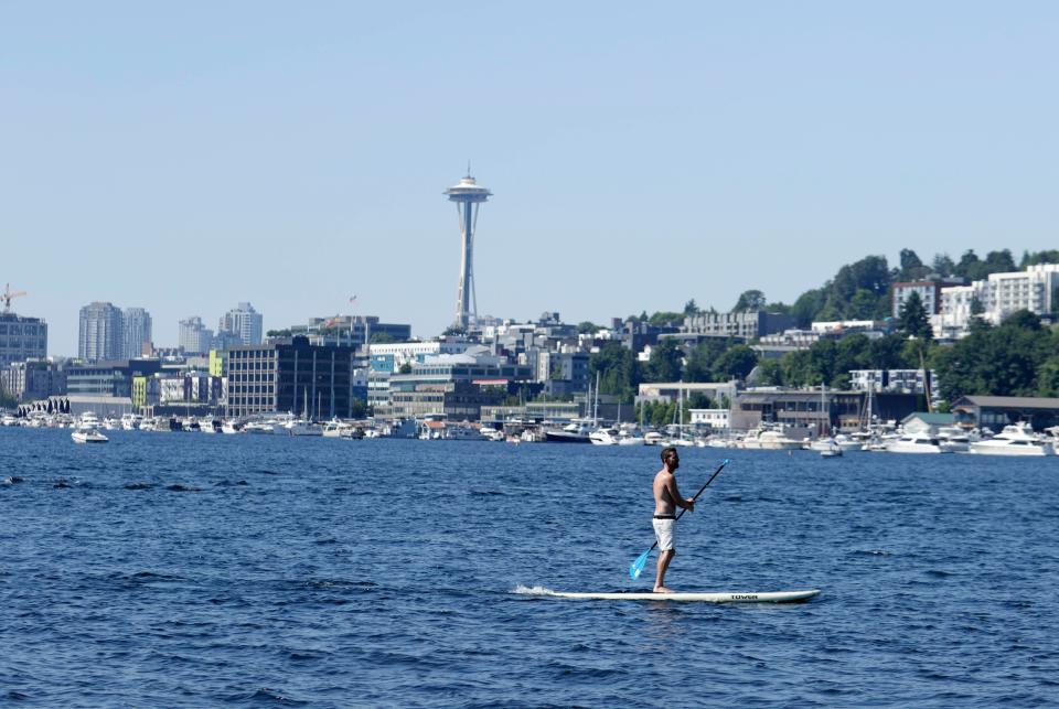 A person rides on a paddle board on Lake Union on June 27 in Seattle during a heat wave hitting the Pacific Northwest.