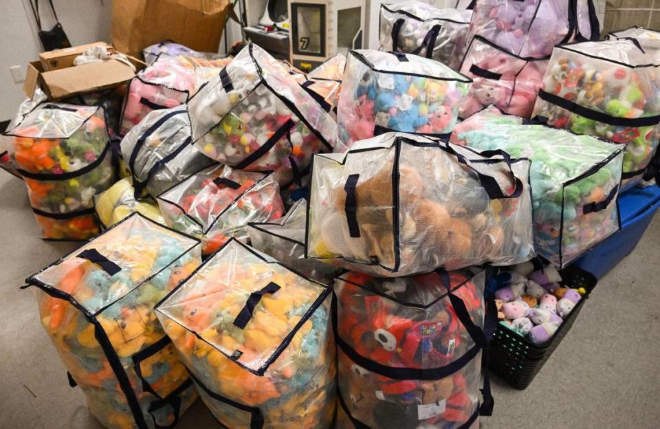 Bundles of plush toy prizes await the claw machines in the back room at Claw Daddy arcade at Fashion Fair in Fresno on Tuesday, Aug. 22, 2023.