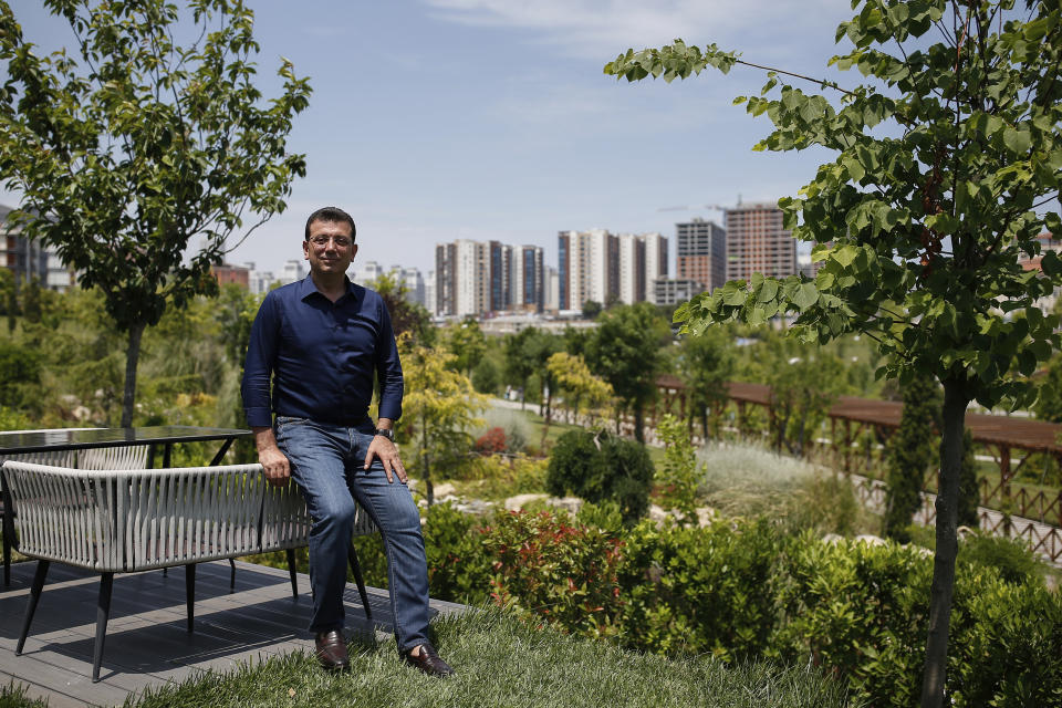 In this Monday, June 17, 2019 photo, Ekrem Imamoglu, candidate of the secular opposition Republican People's Party, or CHP, poses for photographs following an interview with The Associated Press, ahead of the June 23 re-run of Istanbul elections, in Istanbul. Millions of voters in Istanbul go back to the polls for a controversial mayoral election re-run Sunday, as President Recep Tayyip Erdogan's party tries to wrest back control of Turkey's largest city. (AP Photo/Emrah Gurel)