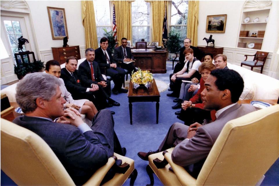President Bill Clinton meets with lesbian and gay leaders in 1992, including AIDS activist Phill Wilson (at right with back to camera), who founded the Black AIDS Institute.