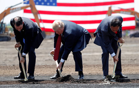 FILE PHOTO: U.S. President Donald Trump (C) takes part in a groundbreaking with Wisconsin Governor Scott Walker (L) and Foxconn Chairman Terry Gou during a visit to Foxconn's new site in Mount Pleasant, Wisconsin, U.S., June 28, 2018. REUTERS/Kevin Lamarque