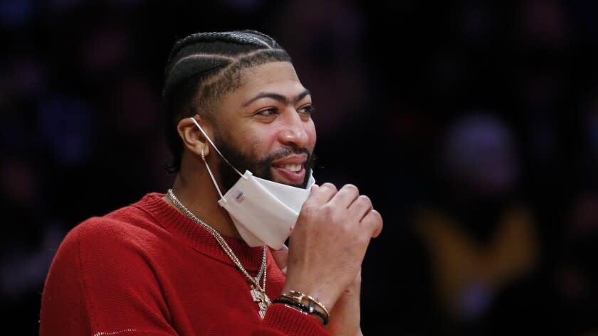 Los Angeles Lakers forward Anthony Davis (3) watches from the bench during the second half of an NBA basketball game against the Minnesota Timberwolves in Los Angeles, Sunday, Jan. 2, 2022. The Laker won 108-103. (AP Photo/Ringo H.W. Chiu)