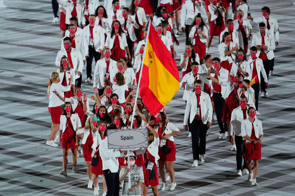 <p>TOKYO, JAPAN - JULY 23: Flag bearers Mireia Belmonte and Saul Craviotto of Team Spain take part in the Parade of Nations during the Opening Ceremony of the Tokyo 2020 Olympic Games at Olympic Stadium on July 23, 2021 in Tokyo, Japan. (Photo by Wei Zheng/CHINASPORTS/VCG via Getty Images)</p> 