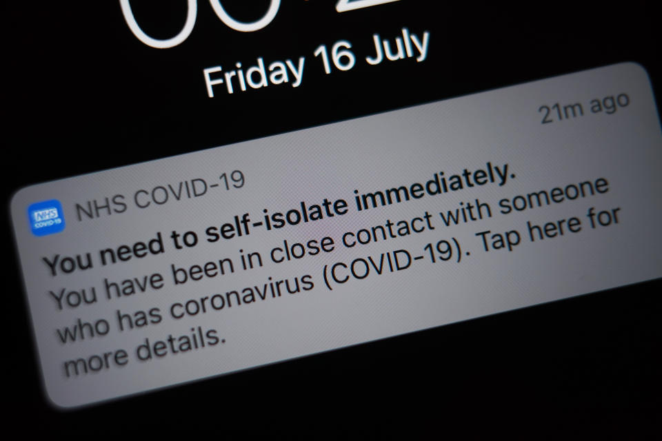 A notification issued by the NHS coronavirus contact tracing app - informing a person of the need to self-isolate immediately, due to having been in close contact with someone who has coronavirus - is displayed on a mobile phone in London, during the easing of lockdown restrictions in England. Picture date: Friday July 16, 2021. (Photo by Yui Mok/PA Images via Getty Images)