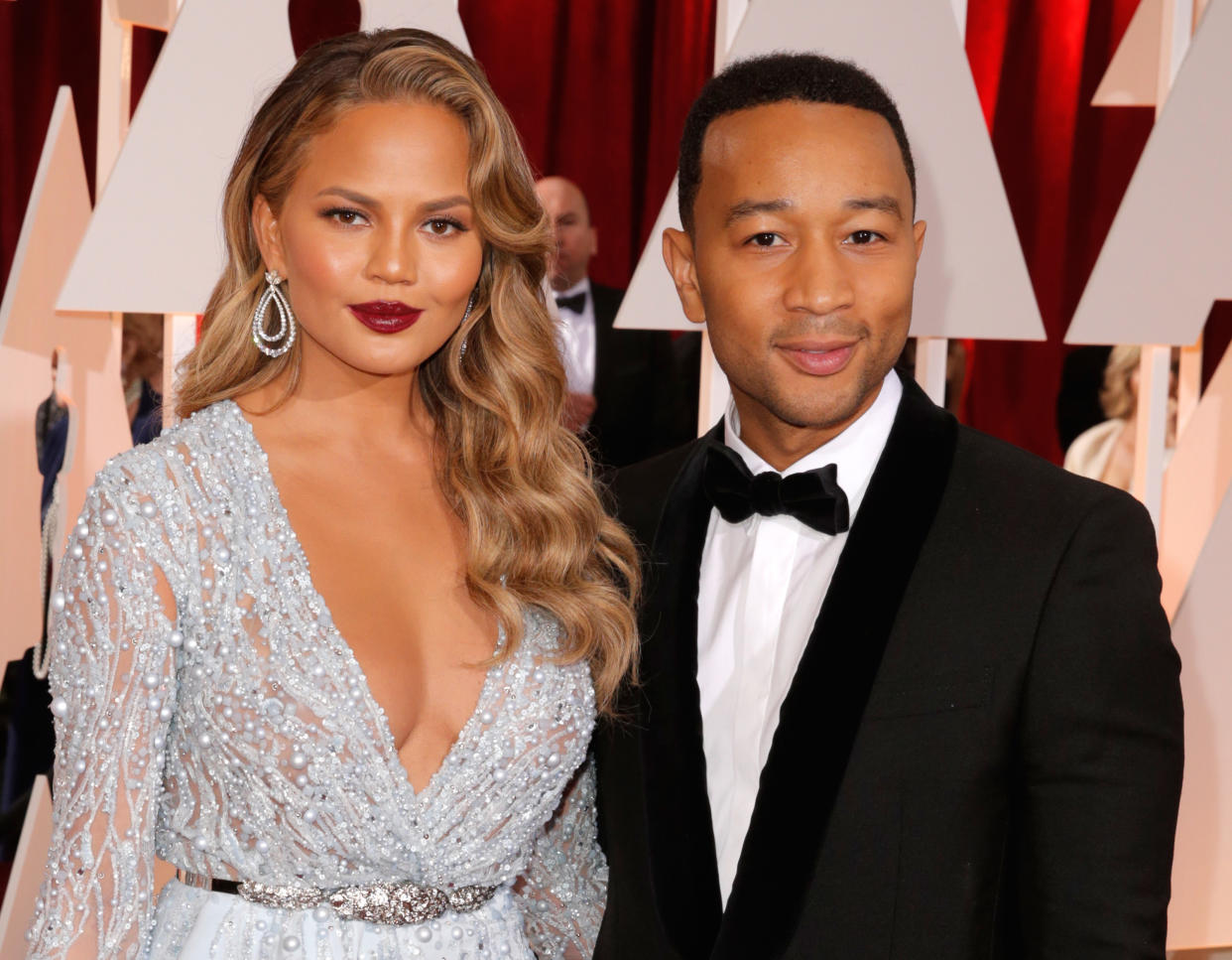 Chrissy Teigen, left, and John Legend arrives at the Oscars on Sunday, Feb. 22, 2015, at the Dolby Theatre in Los Angeles. (Photo by Todd Williamson/Invision/AP)